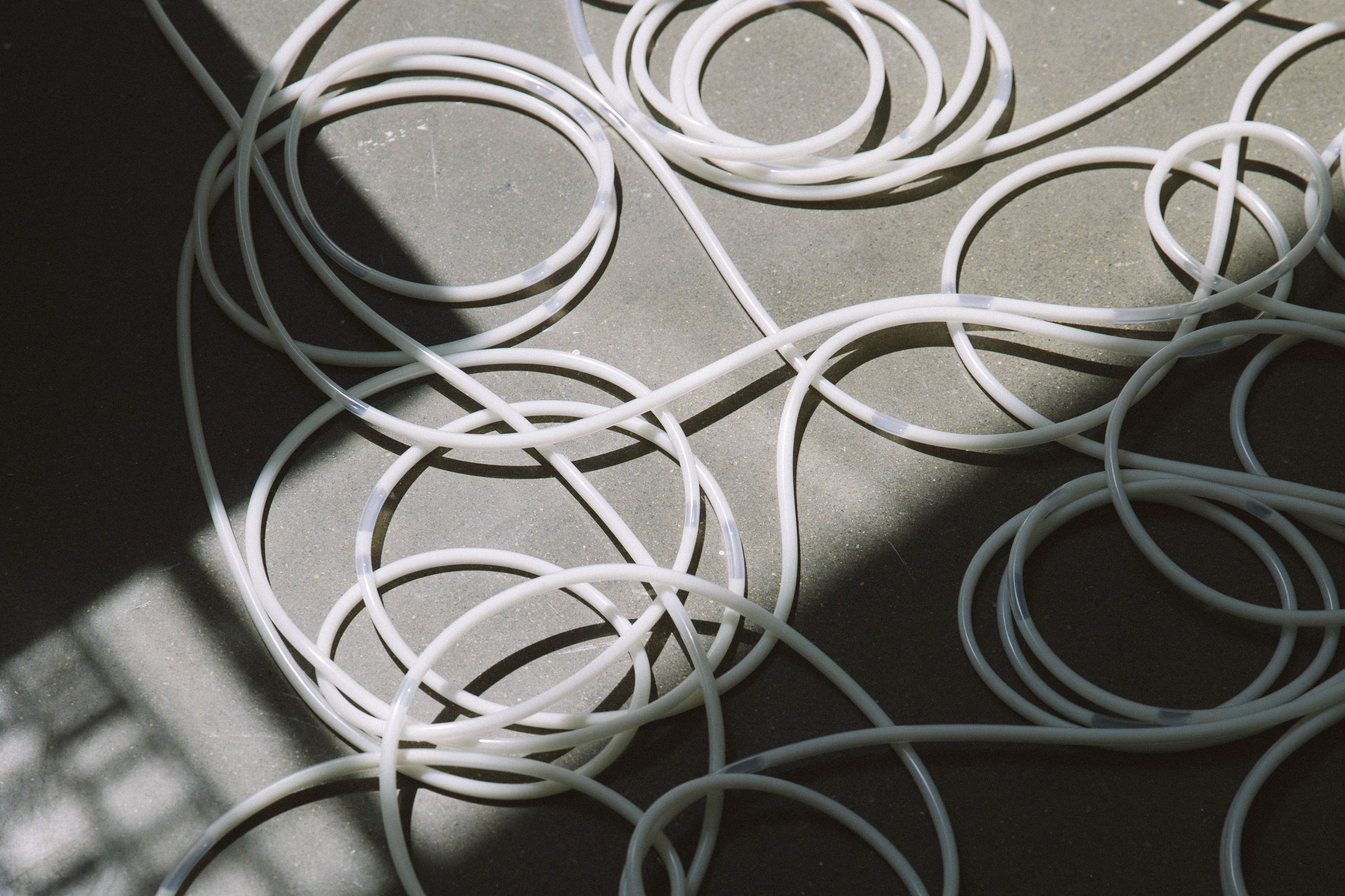 tubing on the floor filled with white liquid