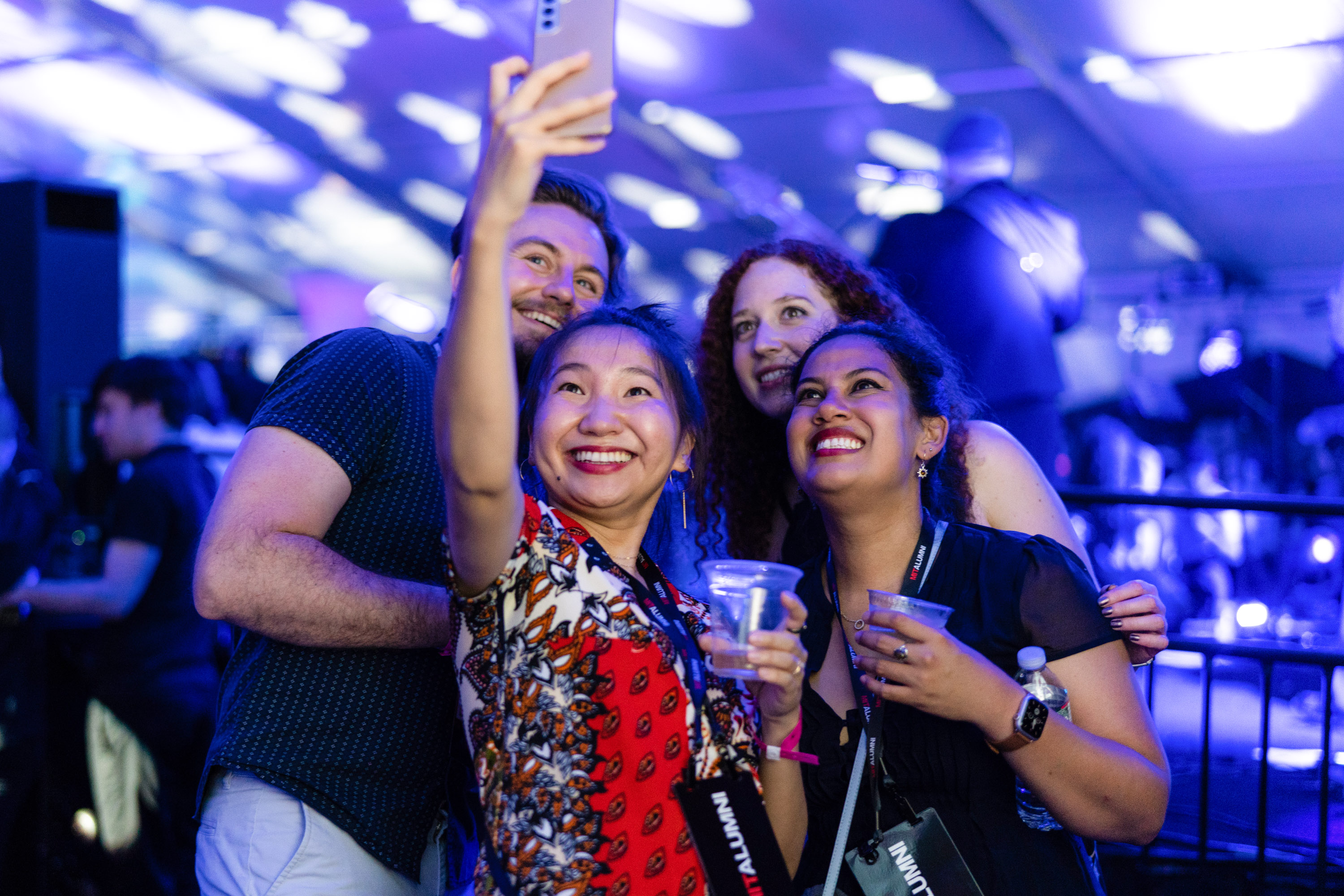 group of friends at party take a cell photo of themselves