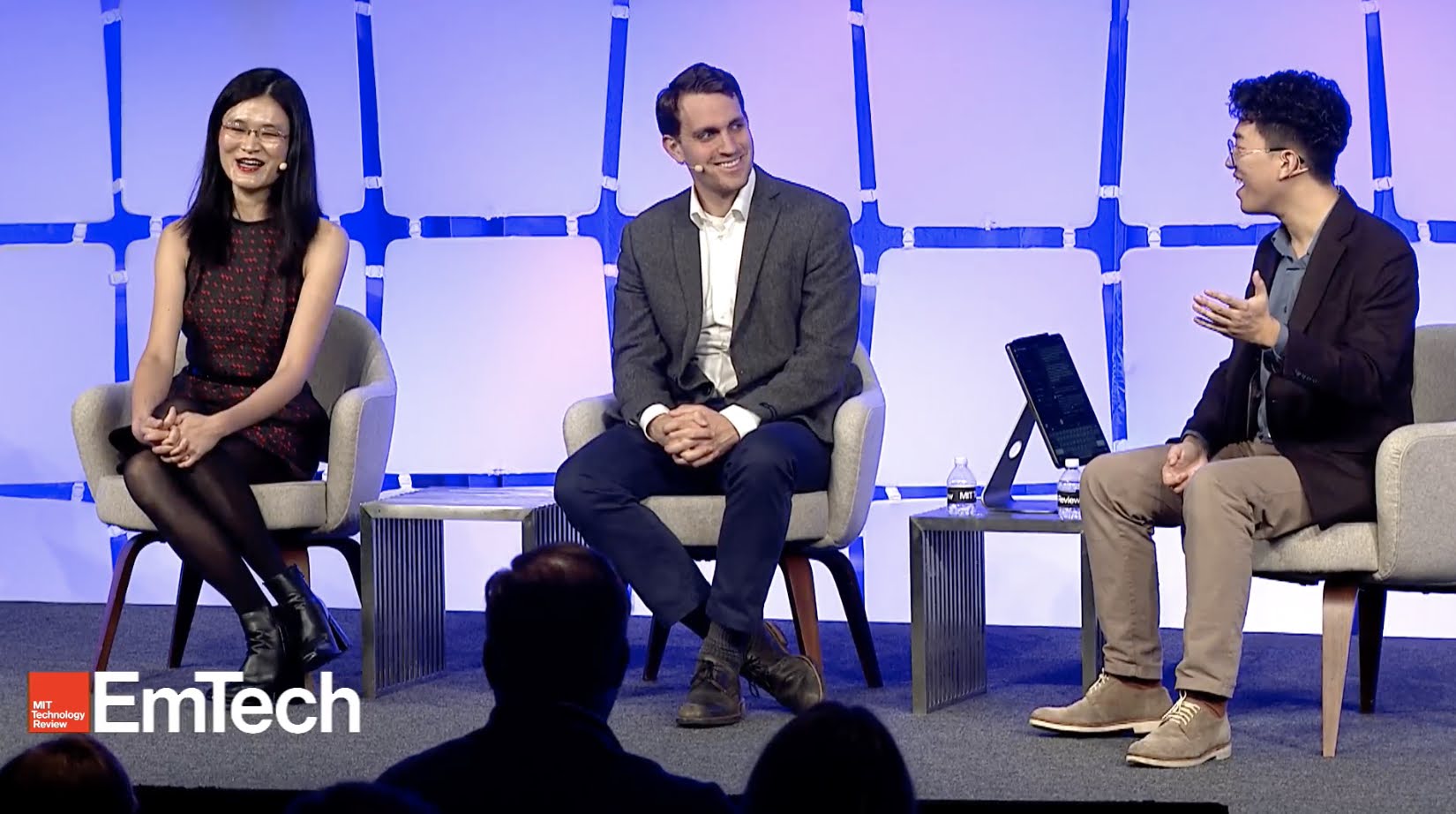 Photo from EmTech MIT showing speakers Yangyang Cheng, Matt Sheehan, and Zeyi Yang