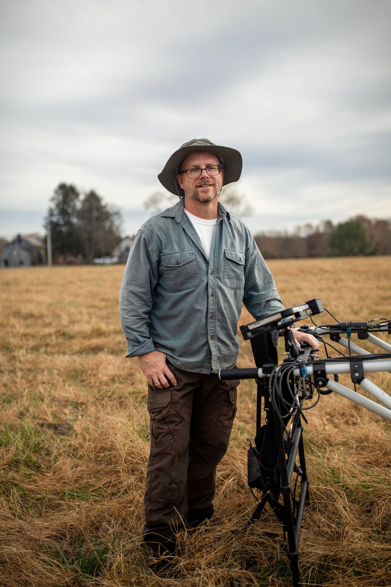 portrait of Jarrod Burks in the field with magnetometric equipment